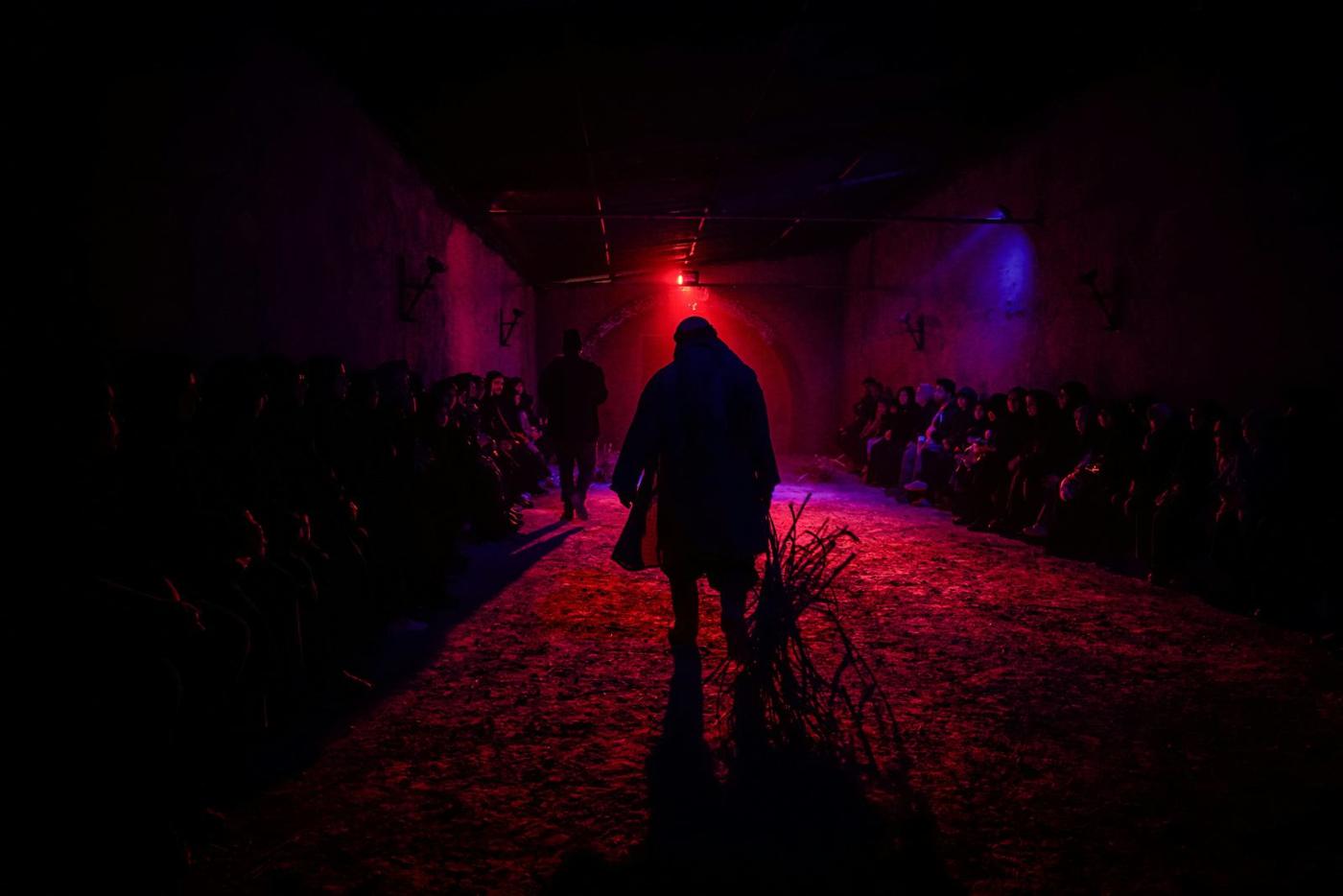 A lone figure silhouetted in deep red haze
