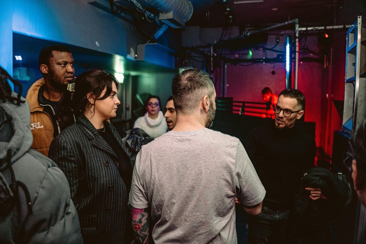People standing in conversation in a theatre bar