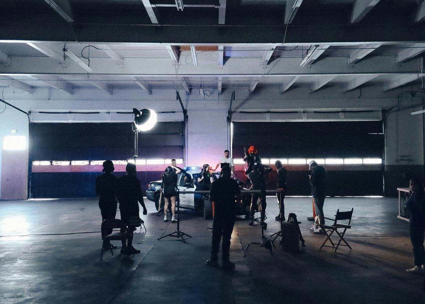 A production crew setting lights on a bare stage