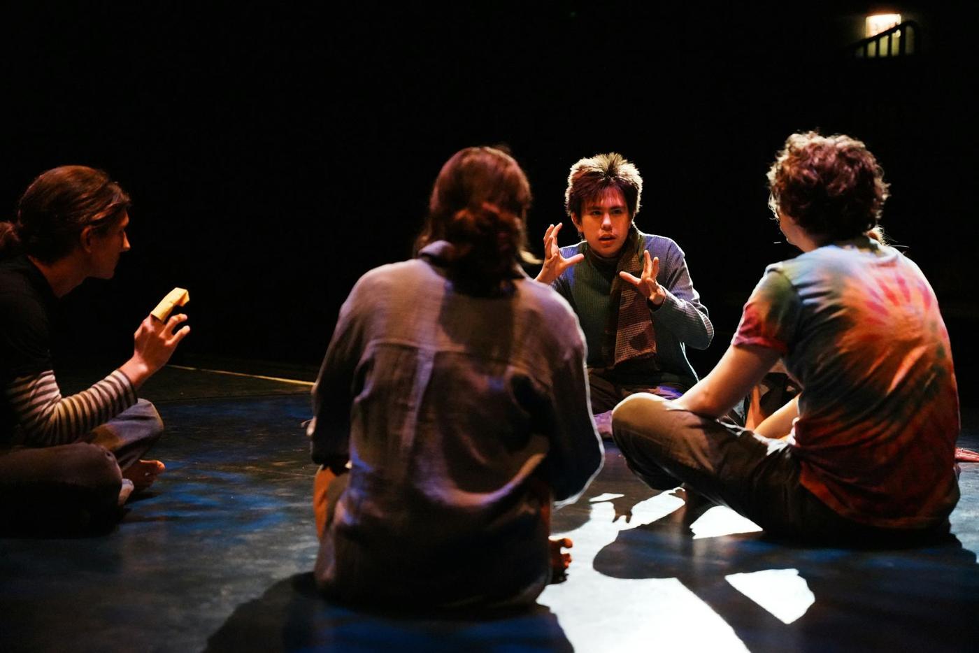 An ensemble standing together on stage